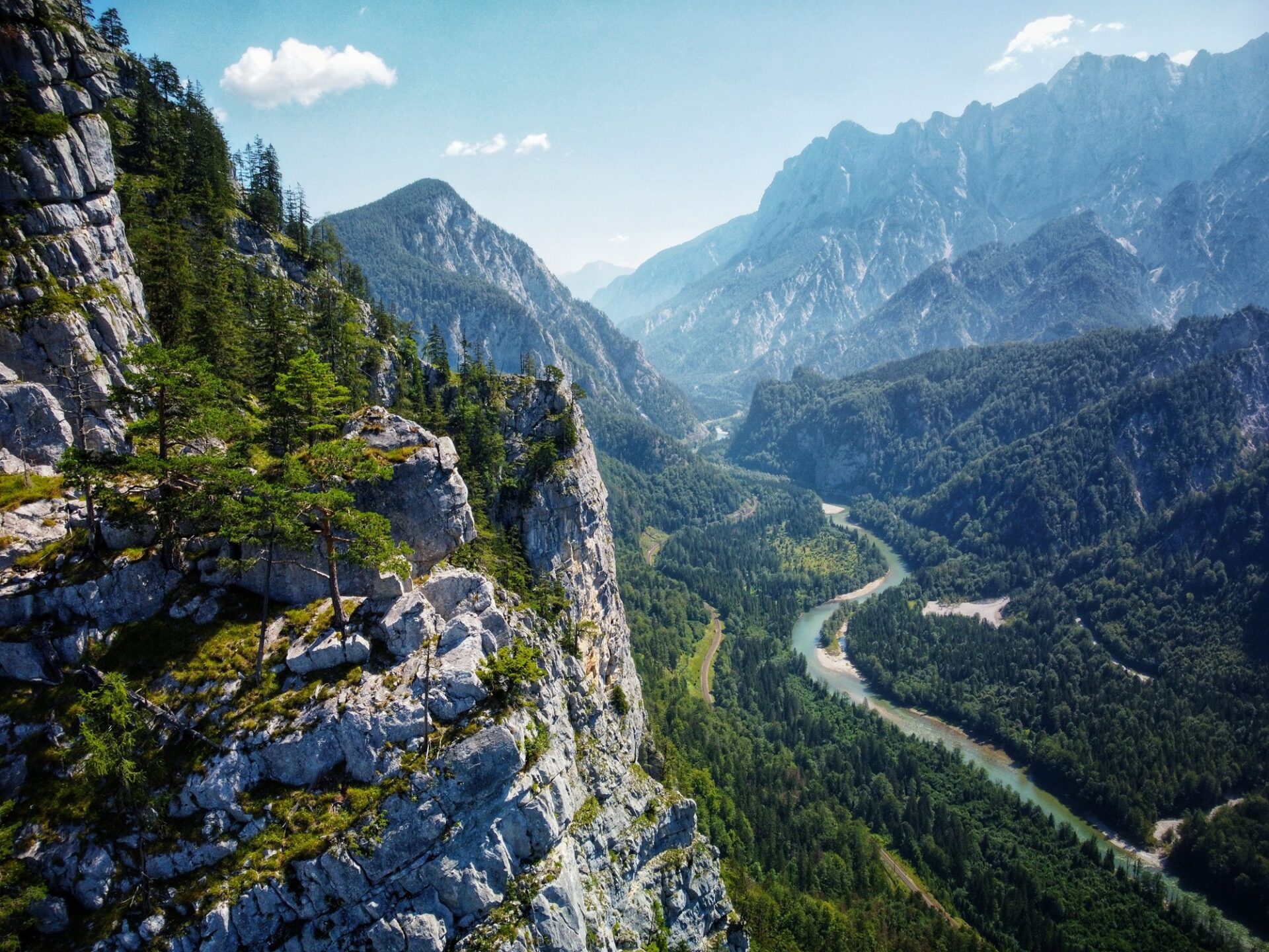 Aerial view of Enns river and lush green vegetation of Gesause National Park in Austria